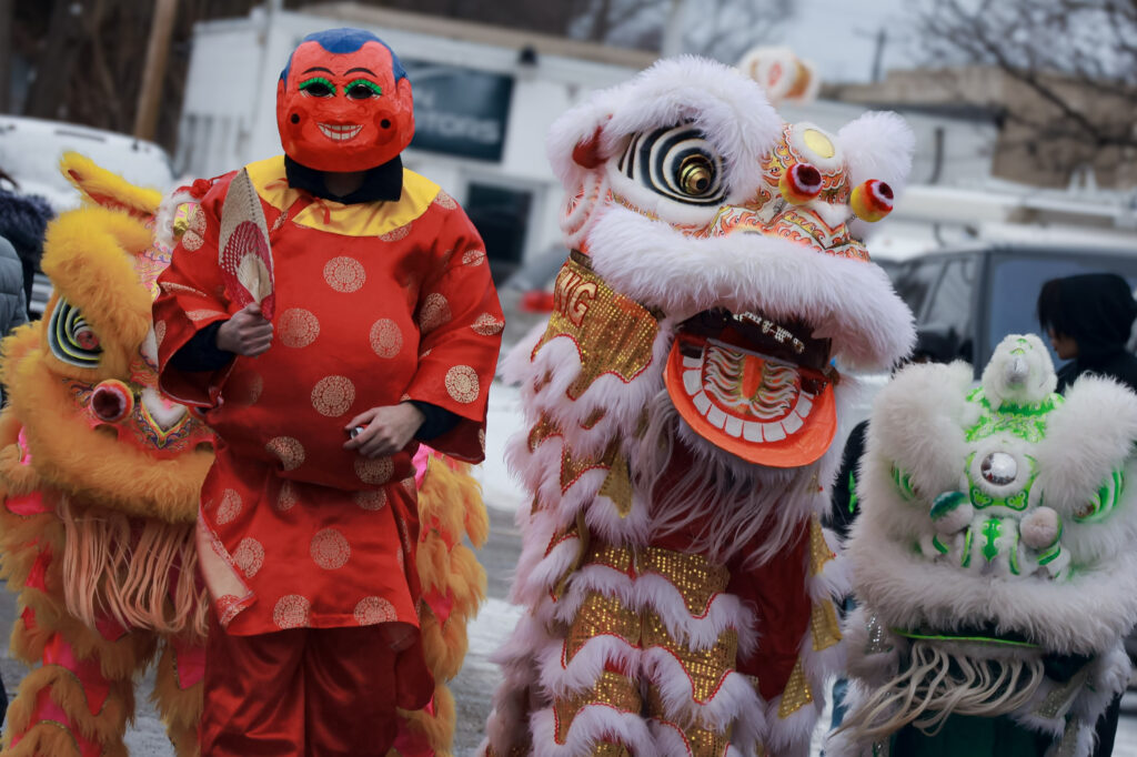 lion dances with “Ong Dia” (the spirit of the earth) in the middle